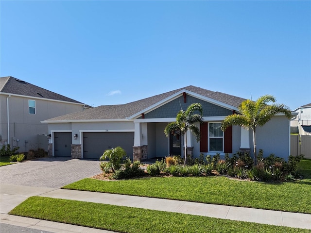 view of front facade with a front yard and a garage