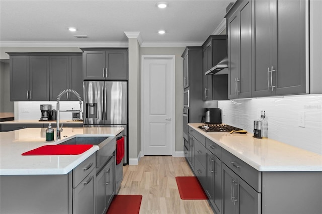 kitchen featuring gray cabinetry and range hood