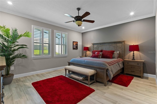 bedroom with light hardwood / wood-style floors, ceiling fan, and ornamental molding