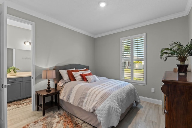 bedroom with ensuite bathroom, crown molding, and light hardwood / wood-style floors