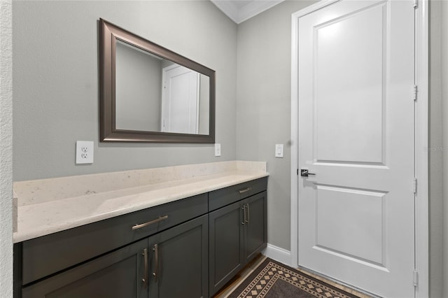 bathroom with vanity and ornamental molding