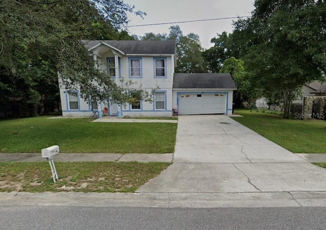 colonial-style house with a garage and a front lawn