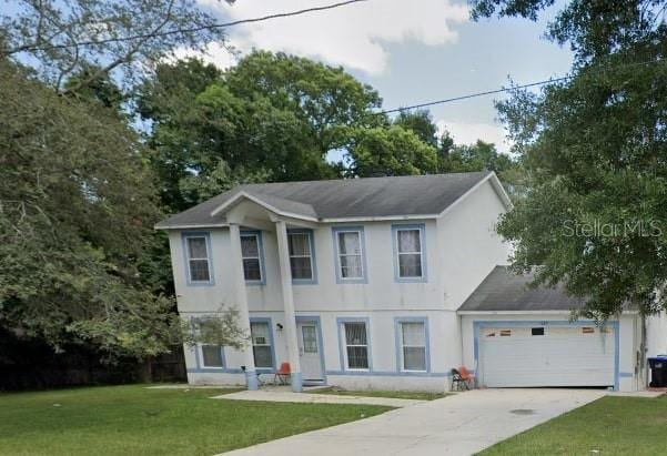 view of front facade featuring a garage and a front yard