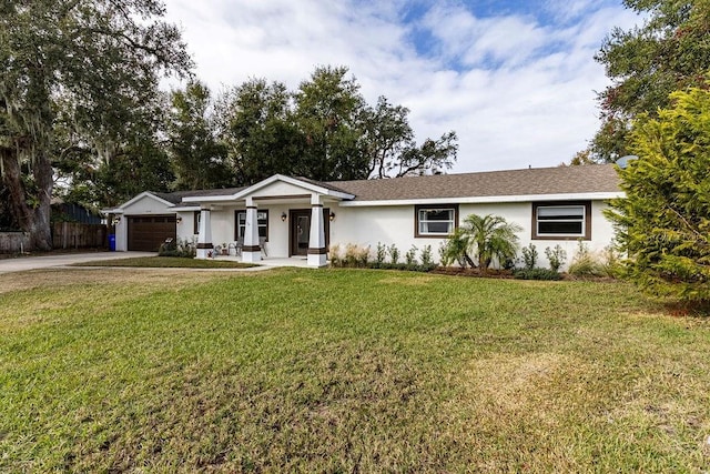 ranch-style home featuring stucco siding, fence, concrete driveway, a front yard, and an attached garage