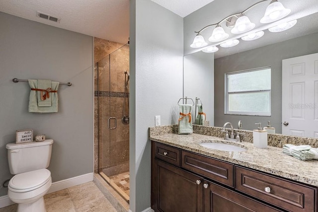 bathroom with a shower with door, vanity, and toilet