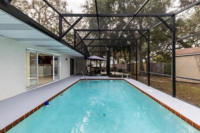 view of swimming pool with glass enclosure