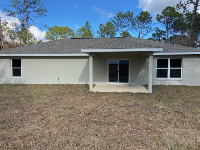 back of property featuring a lawn and a patio area