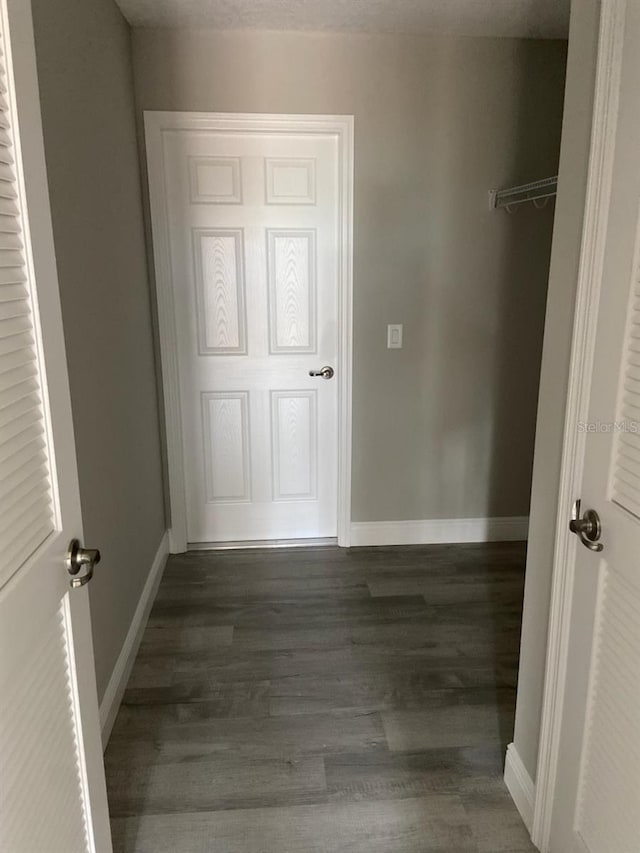 hallway featuring dark hardwood / wood-style floors