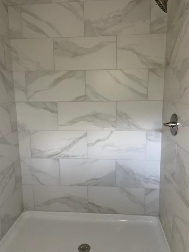 bathroom with tiled shower