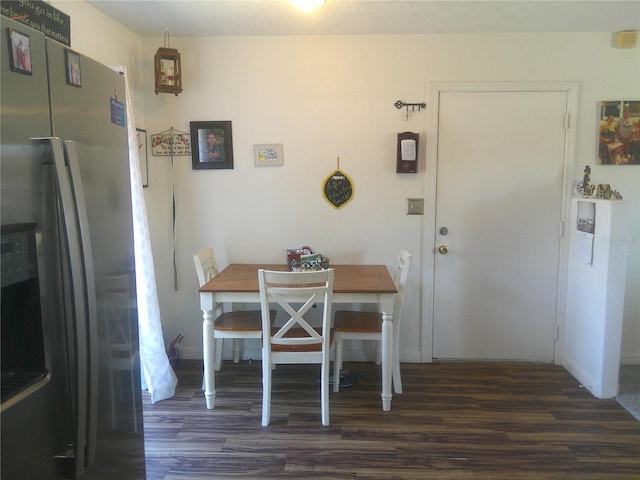 dining space with dark wood-type flooring