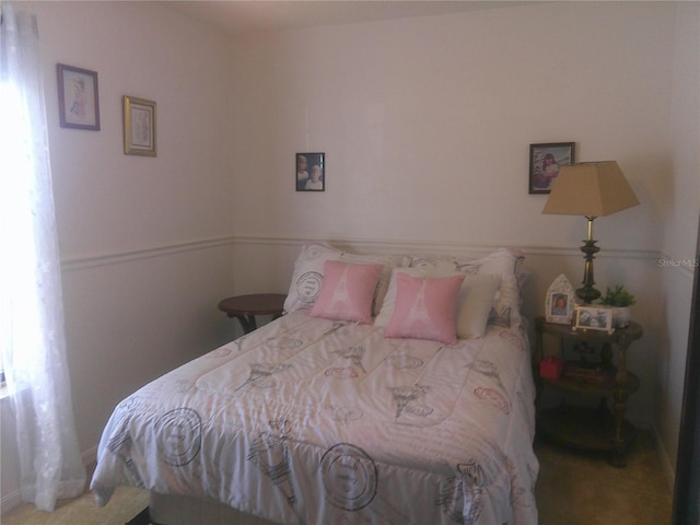 carpeted bedroom featuring multiple windows