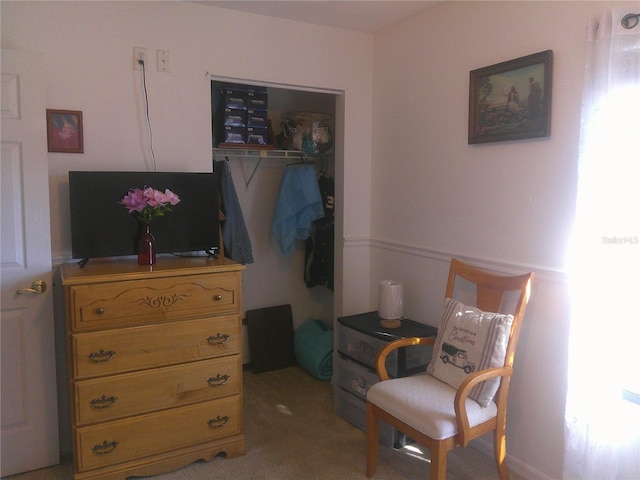 sitting room featuring light colored carpet