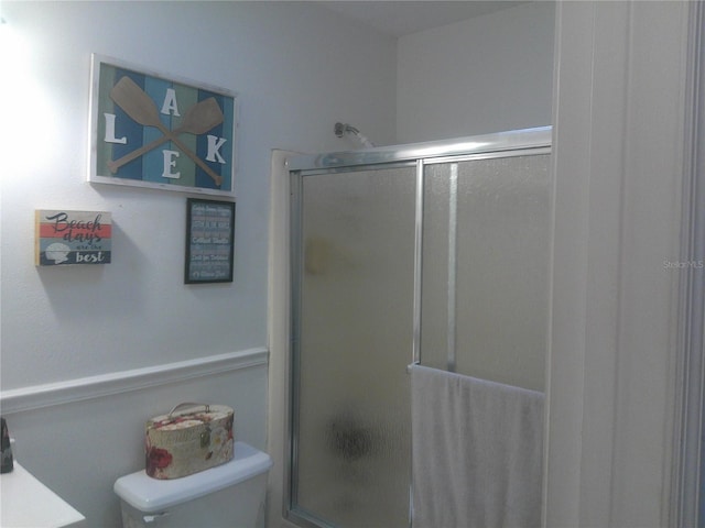 bathroom with toilet and walk in shower