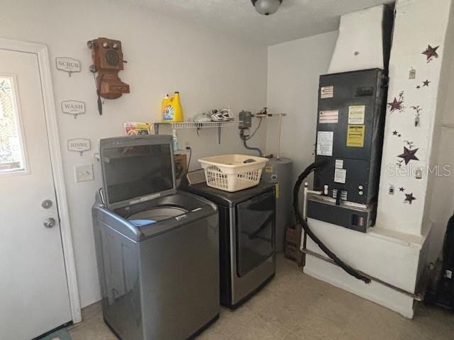 washroom with separate washer and dryer, electric water heater, and heating unit