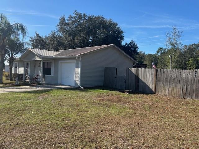 view of side of property with a lawn