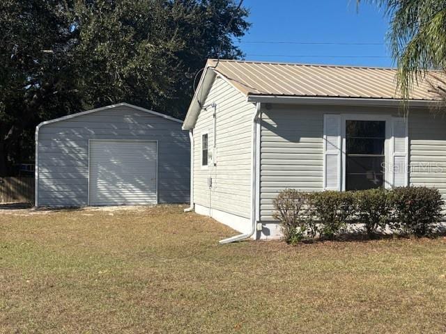 view of property exterior featuring a lawn, a garage, and a shed