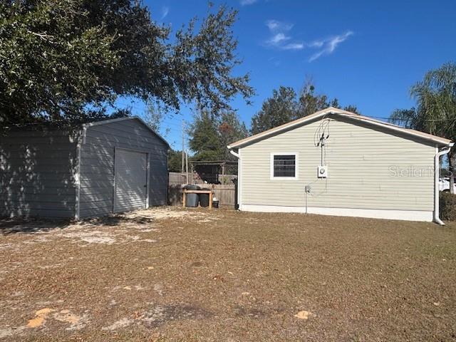 view of home's exterior with an outbuilding