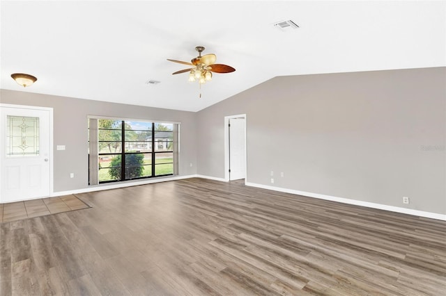 unfurnished living room with ceiling fan, wood-type flooring, and vaulted ceiling