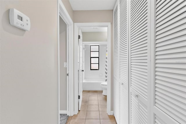 hall with light tile patterned floors