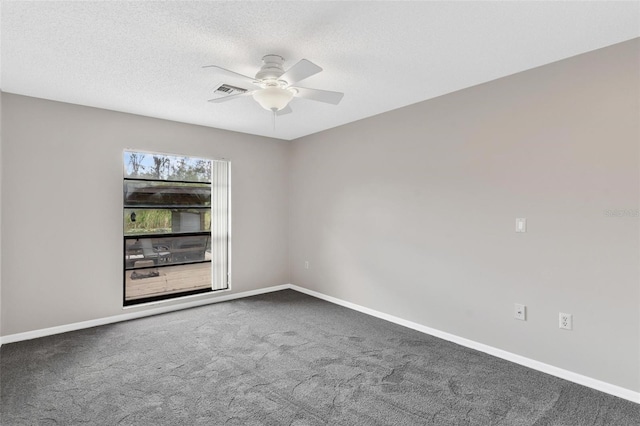 empty room featuring a textured ceiling, carpet floors, and ceiling fan