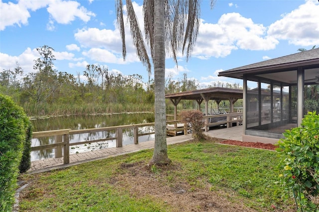 dock area featuring a yard and a water view