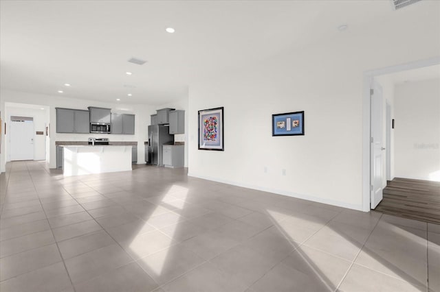 unfurnished living room with light tile patterned flooring