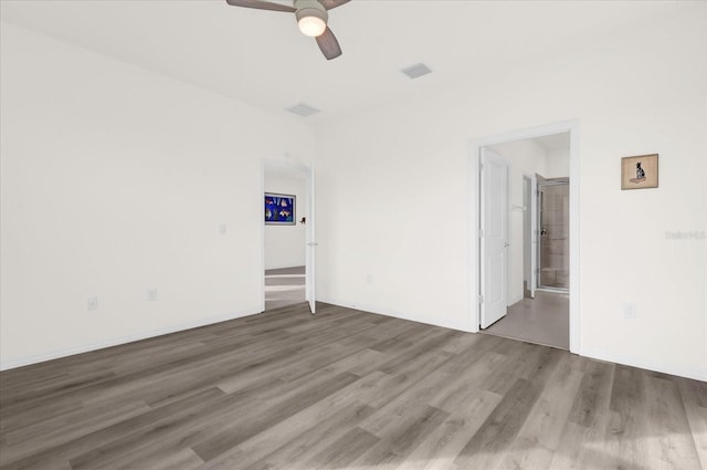 unfurnished room with hardwood / wood-style floors and ceiling fan