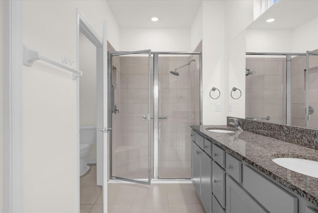 bathroom featuring walk in shower, tile patterned flooring, vanity, and toilet