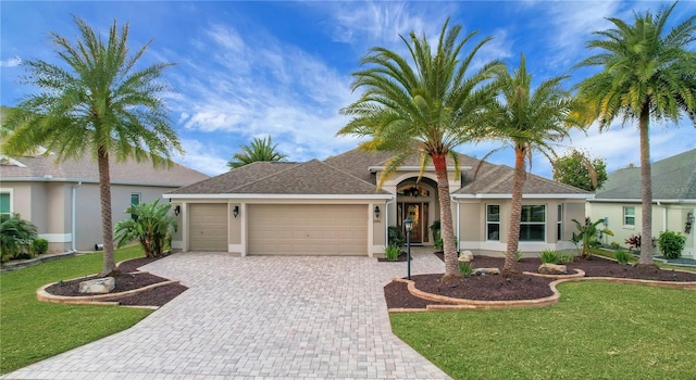 view of front of house with a garage and a front lawn