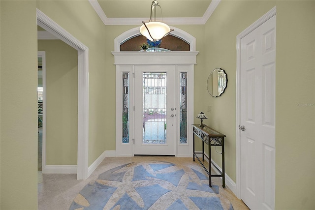 tiled entrance foyer featuring crown molding