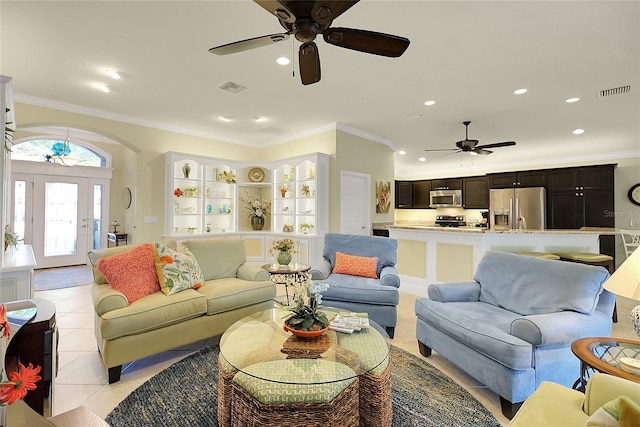 living room with crown molding and light tile patterned floors