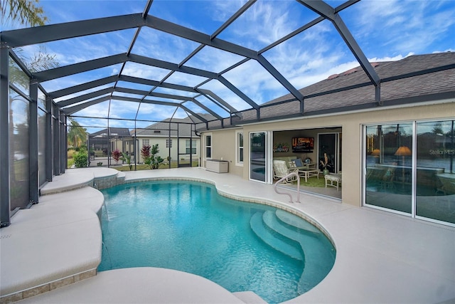 view of swimming pool with glass enclosure and a patio area