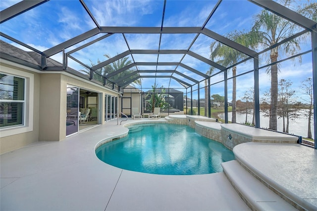 view of swimming pool featuring a water view, glass enclosure, and a patio area