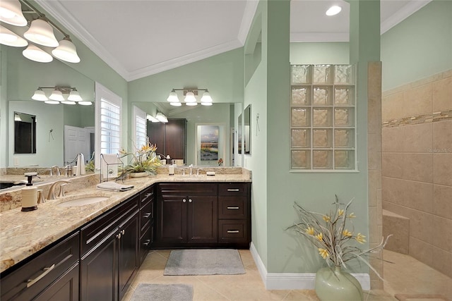 bathroom with tile patterned flooring, crown molding, lofted ceiling, tiled shower, and vanity