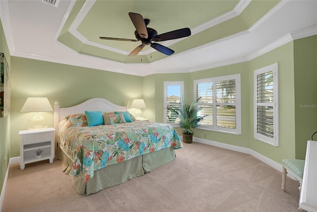 bedroom with ceiling fan, a raised ceiling, ornamental molding, and light carpet