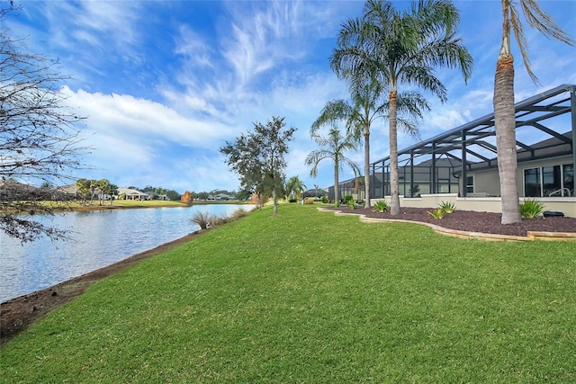 view of yard with a water view and glass enclosure