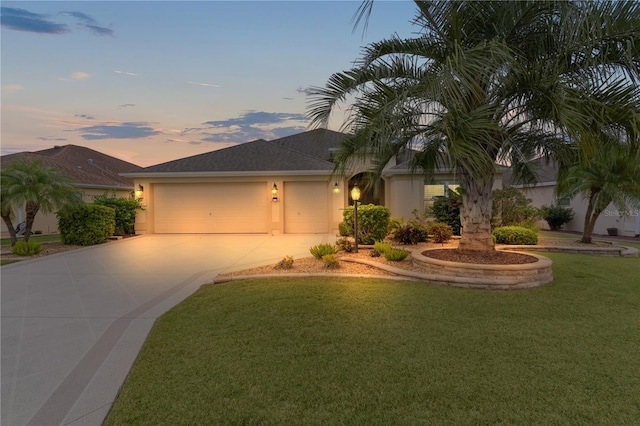 view of front of house featuring a garage and a lawn