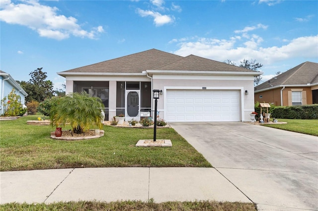 view of front facade with a garage, a front lawn, and a sunroom