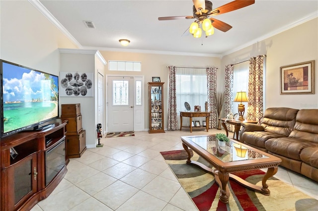 living room with crown molding, ceiling fan, and light tile patterned floors