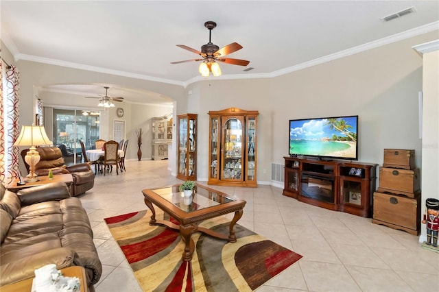 tiled living room with ceiling fan and ornamental molding