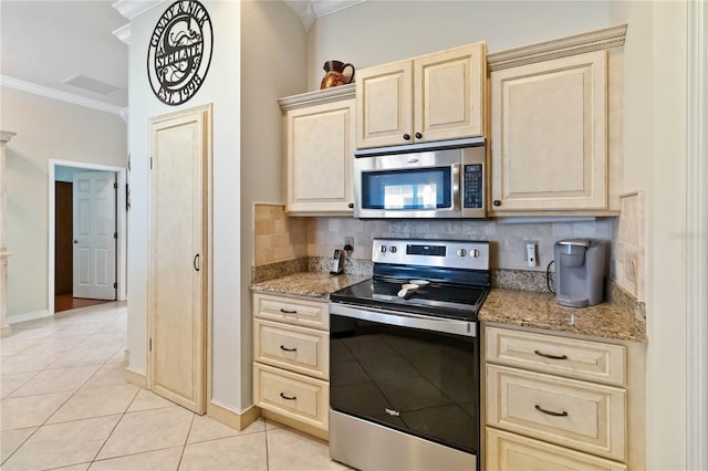 kitchen featuring backsplash, light stone counters, ornamental molding, and stainless steel appliances