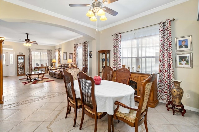 dining room with plenty of natural light, ceiling fan, light tile patterned floors, and crown molding