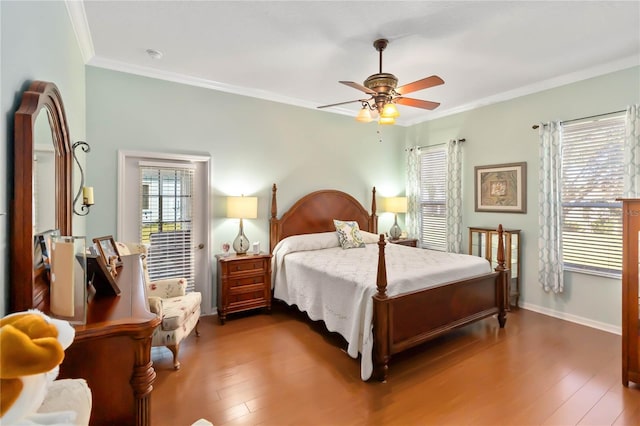 bedroom featuring ceiling fan, crown molding, and dark wood-type flooring