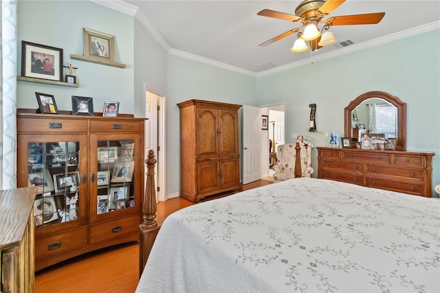 bedroom featuring ceiling fan, light hardwood / wood-style flooring, and ornamental molding