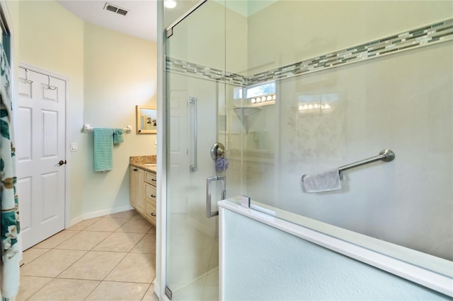 bathroom with tile patterned floors, vanity, and an enclosed shower