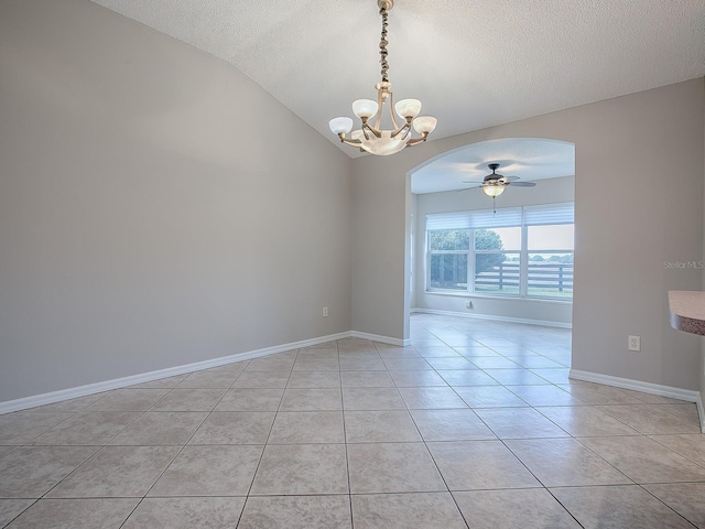 spare room with vaulted ceiling, a textured ceiling, light tile patterned flooring, and ceiling fan with notable chandelier