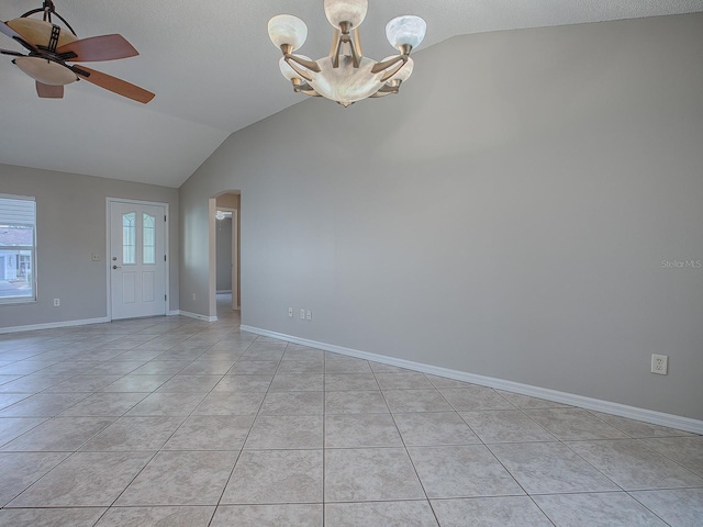 tiled empty room featuring a textured ceiling, ceiling fan with notable chandelier, and lofted ceiling