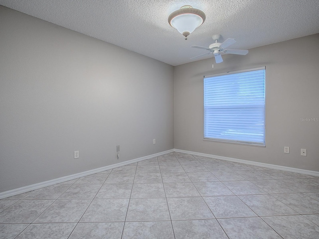 tiled empty room with a textured ceiling and ceiling fan