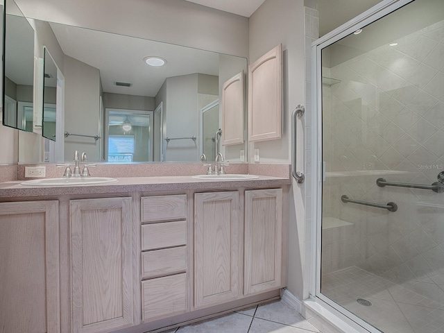 bathroom with tile patterned floors, vanity, and walk in shower