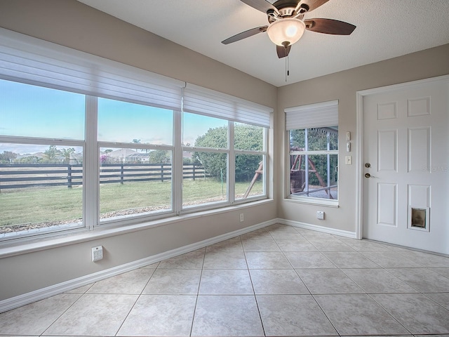 interior space featuring ceiling fan, a healthy amount of sunlight, and a textured ceiling